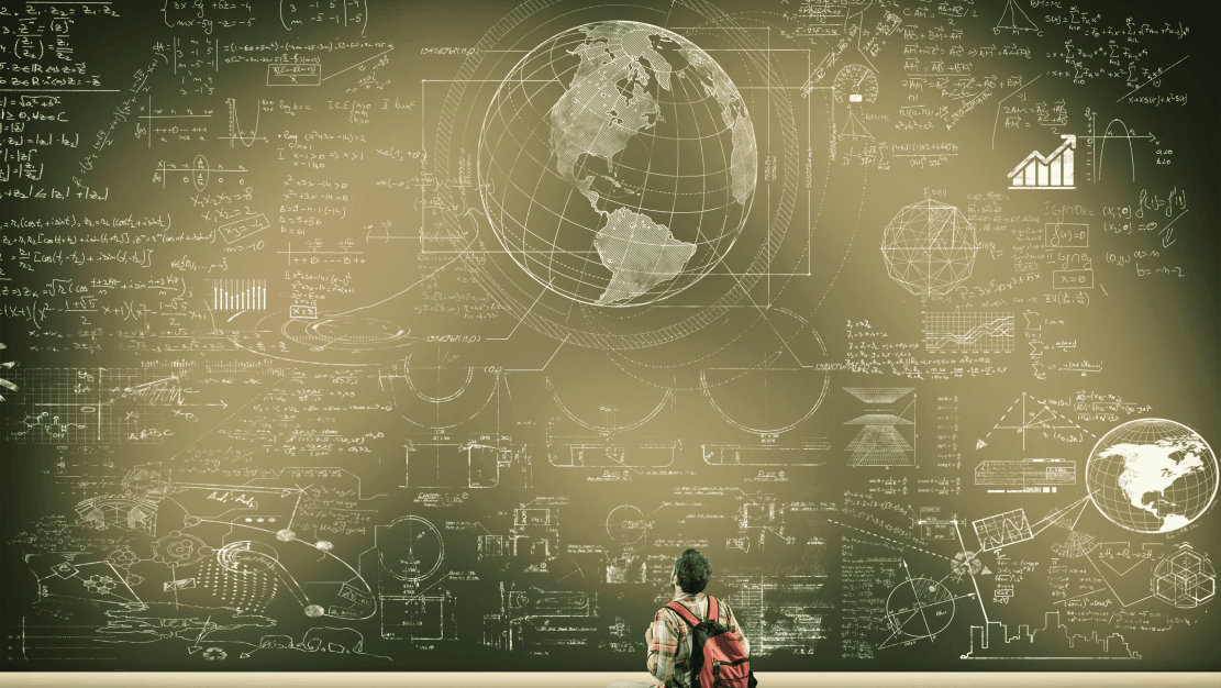 A man in front of a vast blackboard filled with images and math formulas..